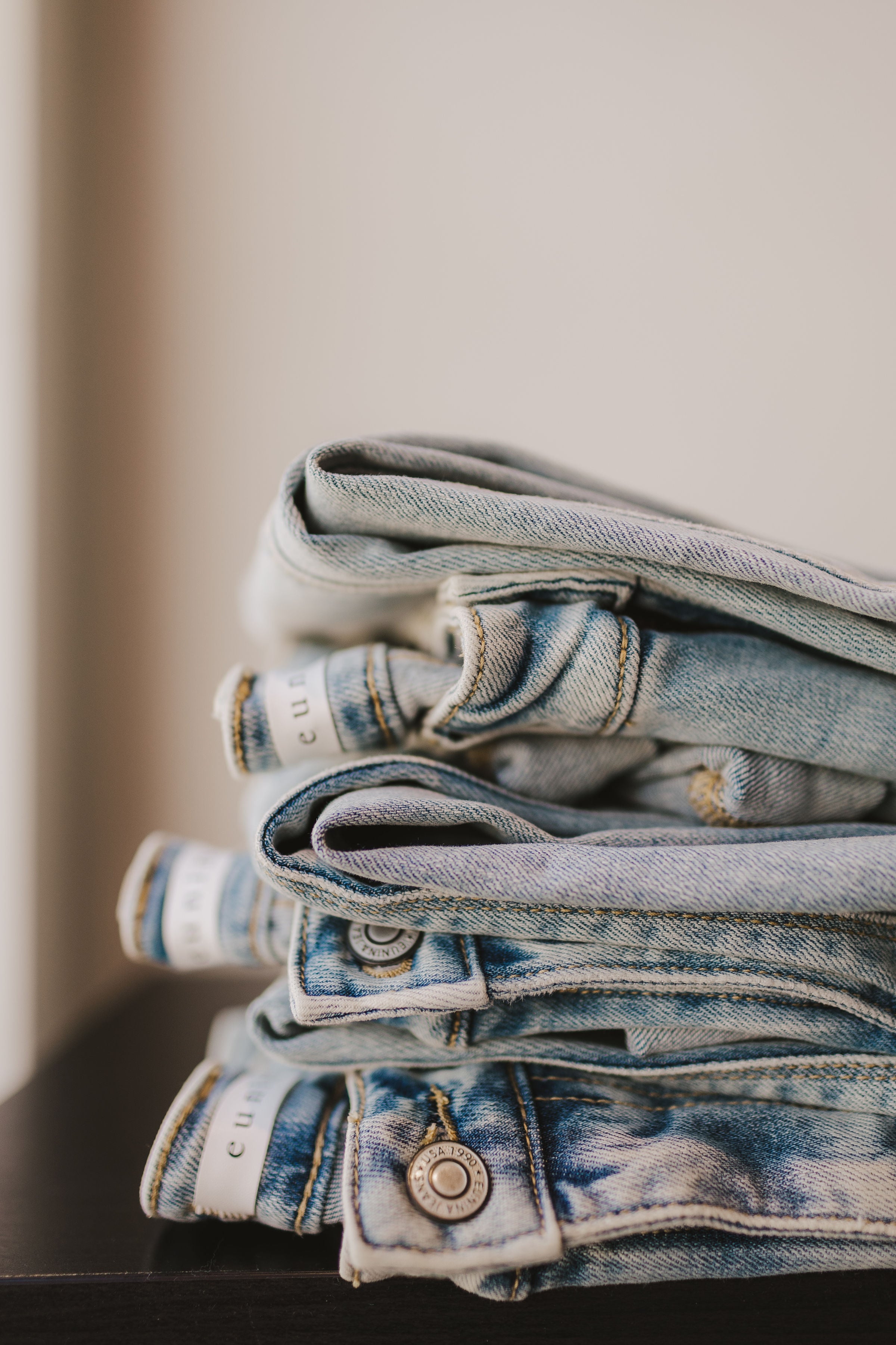 Stack of jeans at Roux Collective Boutique in Paso Robles.